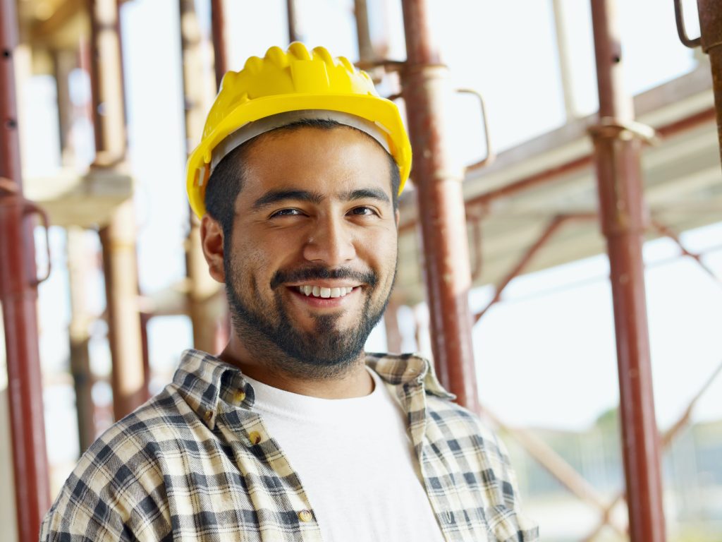 Portrait Of Hispanic Construction Worker In Building Site
